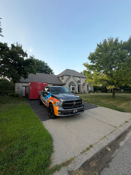 Rocket Roofing truck and dumpster in the driveway of a west metro home during a roof replacement