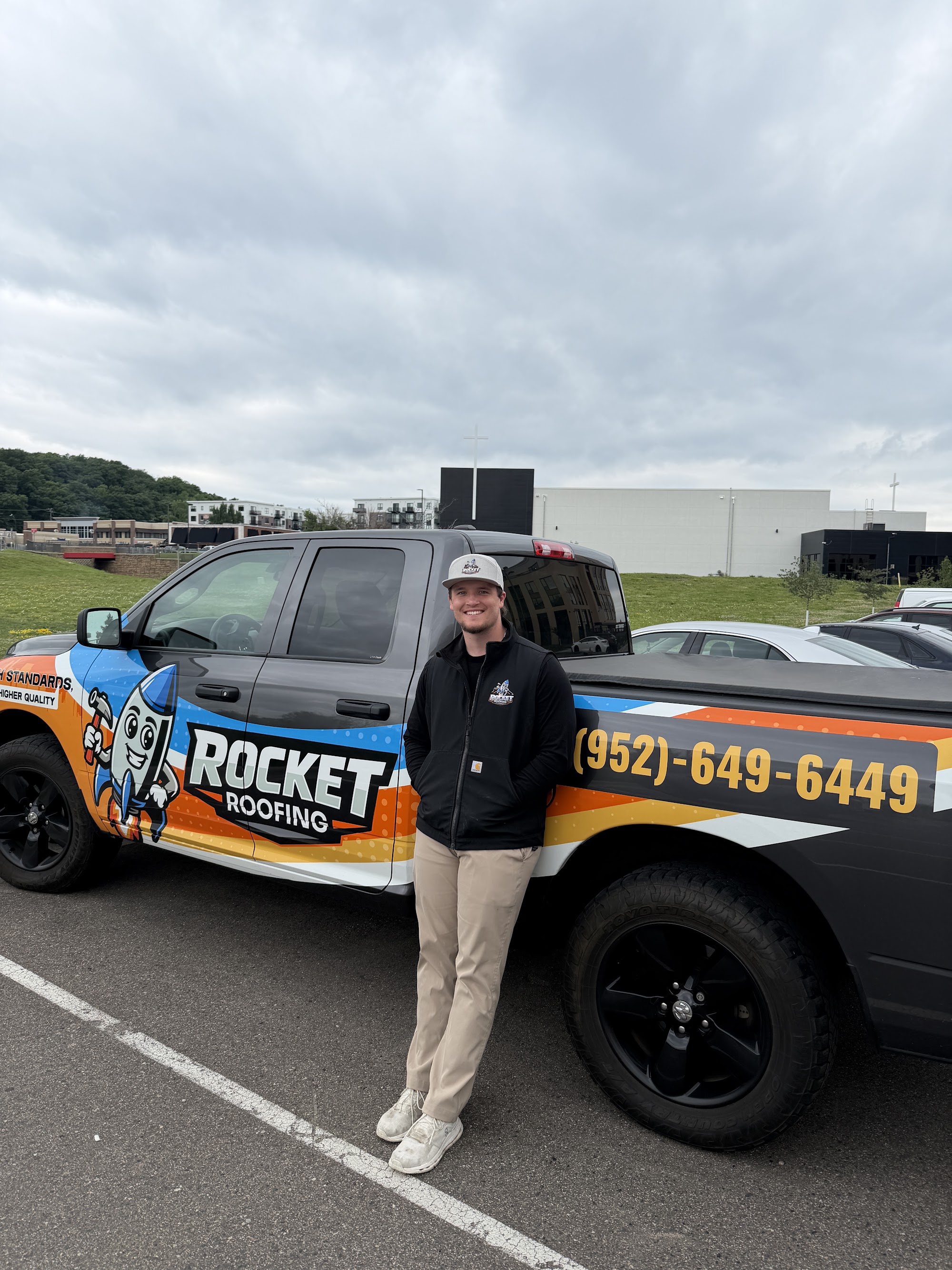 Owen, owner of Rocket Roofing, next to the company truck.